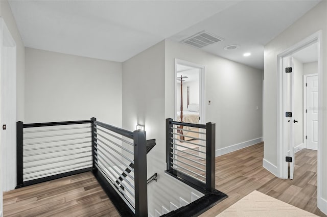 staircase with hardwood / wood-style flooring