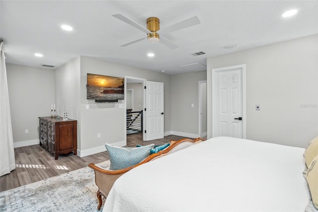 bedroom with ceiling fan and hardwood / wood-style flooring