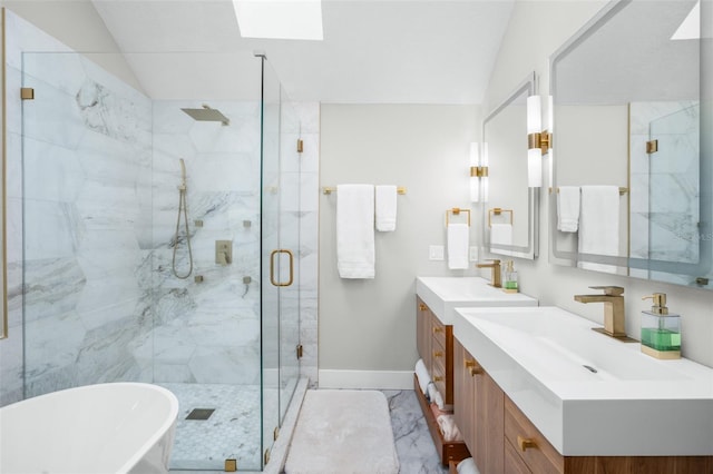 bathroom featuring vanity, independent shower and bath, and vaulted ceiling with skylight