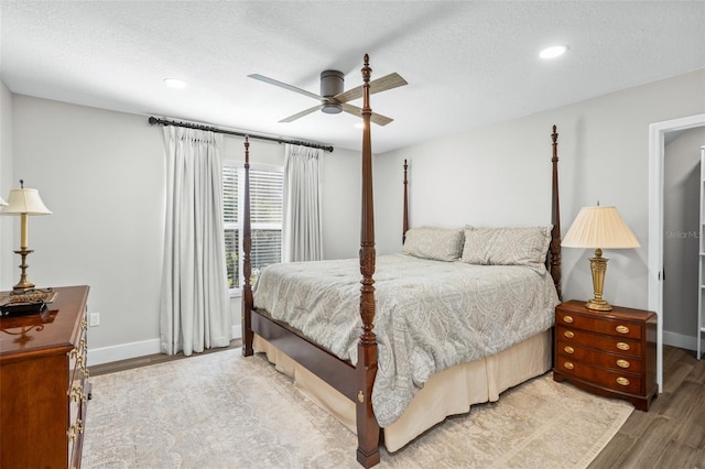 bedroom featuring a textured ceiling, hardwood / wood-style flooring, and ceiling fan