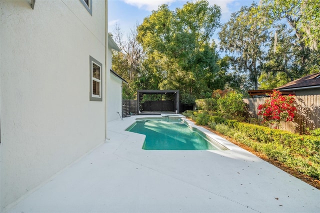 view of swimming pool featuring a patio and a hot tub