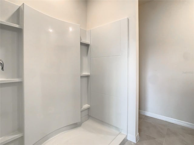 bathroom with tile patterned floors and walk in shower