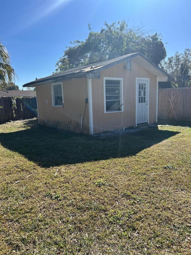 rear view of house featuring a lawn