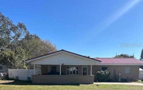 view of front of house featuring a front yard and metal roof