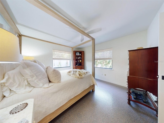 bedroom with carpet, ceiling fan, and multiple windows