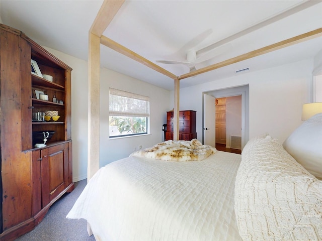 carpeted bedroom featuring ceiling fan and a closet