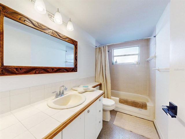 full bathroom with vanity, toilet, decorative backsplash, and shower / tub combo