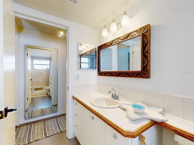 bathroom featuring vanity and toilet