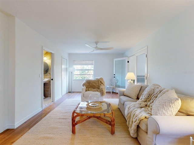 living room featuring light wood-type flooring and ceiling fan