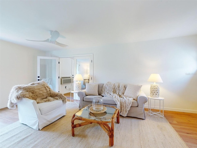 living room featuring light wood-type flooring and ceiling fan