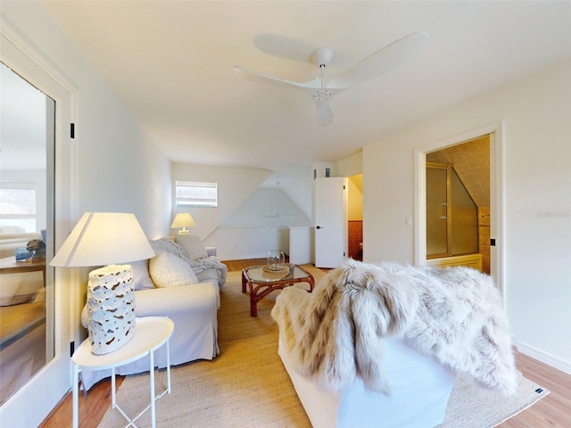 living room featuring ceiling fan and light hardwood / wood-style flooring