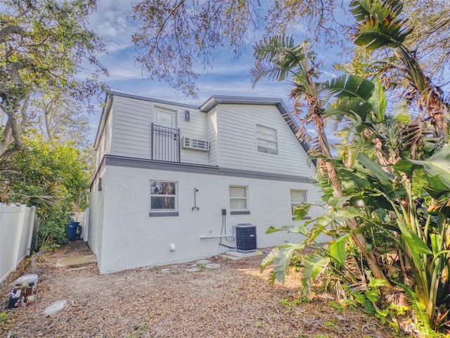 back of house featuring central AC unit and a balcony