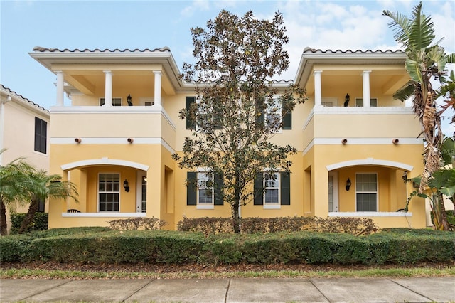 mediterranean / spanish-style home featuring a balcony