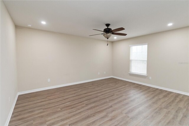 unfurnished room with ceiling fan and light hardwood / wood-style flooring