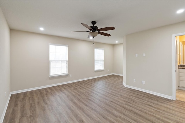 spare room featuring ceiling fan and light wood-type flooring