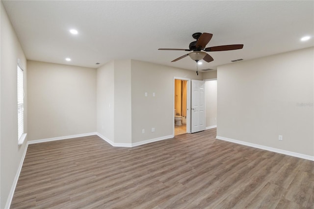 unfurnished room with ceiling fan and light wood-type flooring