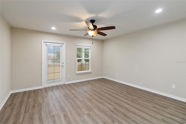 spare room with hardwood / wood-style floors and ceiling fan