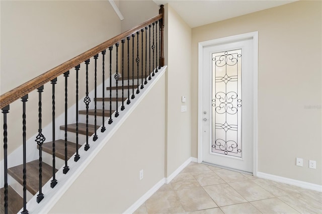 foyer entrance with light tile patterned floors