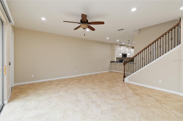 interior space with ceiling fan