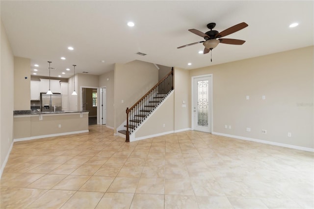 unfurnished living room featuring ceiling fan and light tile patterned floors