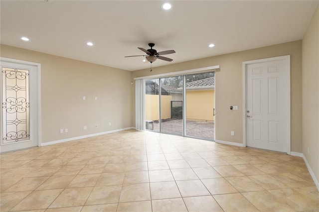 empty room with ceiling fan and light tile patterned flooring