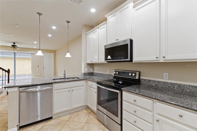 kitchen featuring pendant lighting, sink, ceiling fan, white cabinetry, and stainless steel appliances