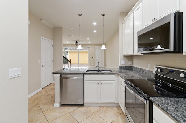 kitchen with appliances with stainless steel finishes, ceiling fan, sink, decorative light fixtures, and white cabinetry