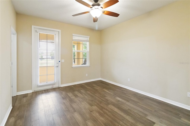 unfurnished room with dark hardwood / wood-style flooring and ceiling fan