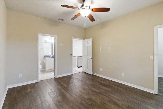 unfurnished bedroom featuring connected bathroom, ceiling fan, dark hardwood / wood-style flooring, and a textured ceiling