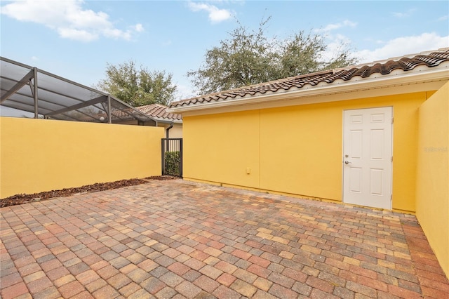 view of patio / terrace featuring a lanai