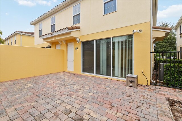 rear view of property featuring a patio area