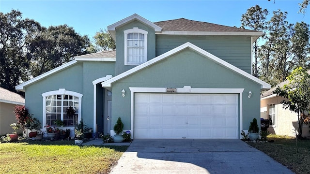 front of property with a garage and a front lawn