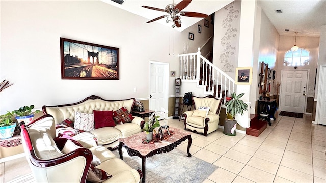 living room with ceiling fan, light tile patterned floors, and high vaulted ceiling