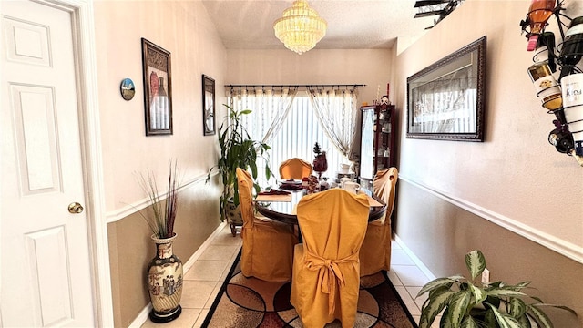 tiled dining space with a notable chandelier