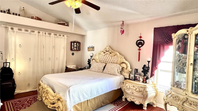 bedroom featuring ceiling fan, dark hardwood / wood-style flooring, a textured ceiling, and vaulted ceiling