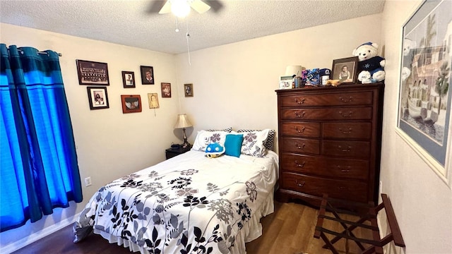 bedroom featuring ceiling fan, wood-type flooring, and a textured ceiling