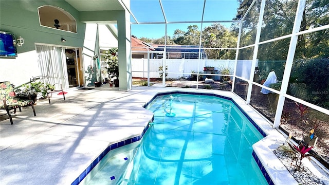 view of pool with a patio and glass enclosure