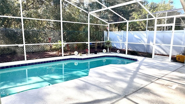 view of swimming pool featuring a patio area and a lanai