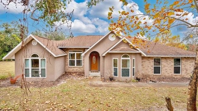 ranch-style home with a front yard