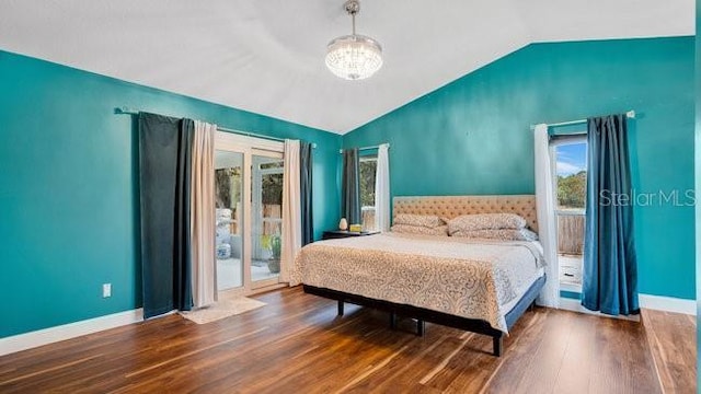 bedroom featuring access to outside, wood-type flooring, vaulted ceiling, and a notable chandelier