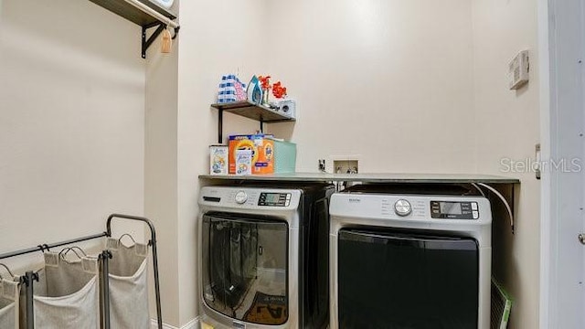 clothes washing area featuring washer and dryer