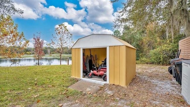 view of outdoor structure featuring a yard and a water view