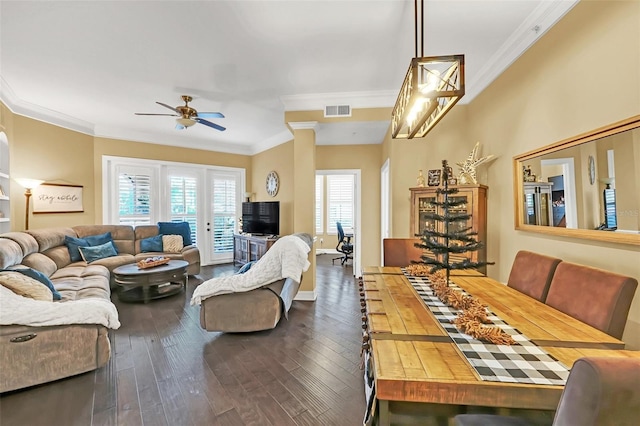 living room with ceiling fan, dark wood-type flooring, and ornamental molding