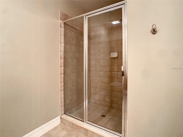 bathroom featuring tile patterned floors and a shower with door