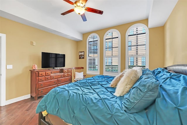 bedroom with ceiling fan and hardwood / wood-style floors