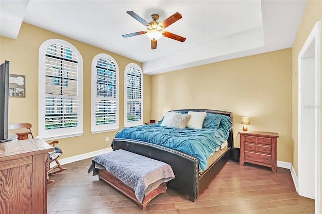 bedroom with ceiling fan and hardwood / wood-style floors