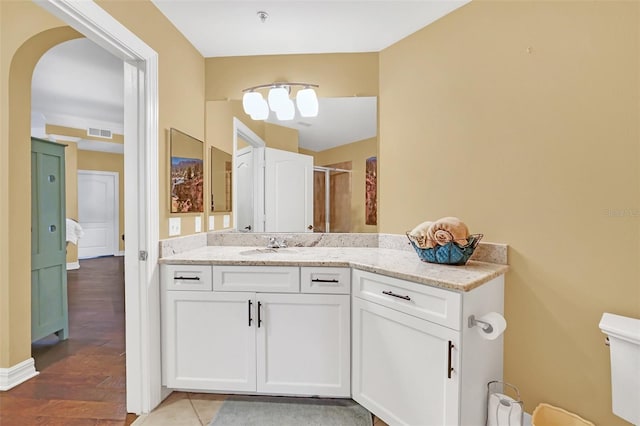 bathroom featuring hardwood / wood-style flooring, vanity, and an enclosed shower