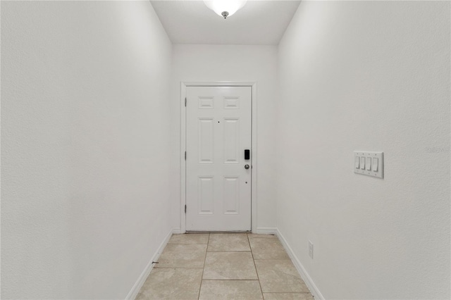 doorway with light tile patterned floors