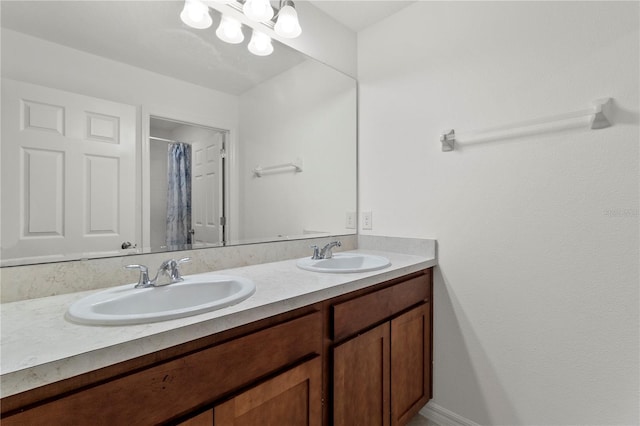 bathroom featuring curtained shower and vanity