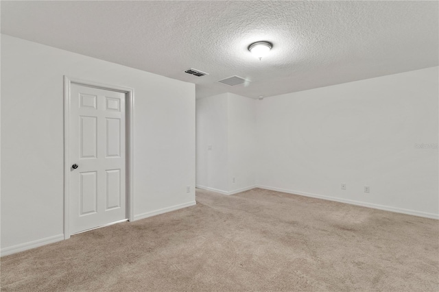 carpeted spare room with a textured ceiling